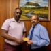 Managing Director of Assuria Guyana, Mr. Yogindra Arjune presents the first Assuria Executive Lounge Pass to Governor of Bank of Guyana, Dr. Gobind Ganga on May 12th 2026 at the Bank of Guyana.