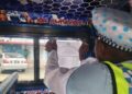 Police putting up fare structure in a minibus