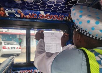 Police putting up fare structure in a minibus