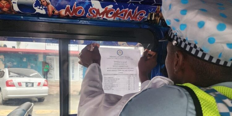 Police putting up fare structure in a minibus