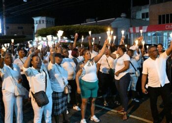 Participants lift their candles during the People’s National Movement’s (PNM) Candlelight Vigil in Defence of Democracy and Freedom in San Juan on Wednesday evening. —Photo: ISHMAEL SALANDY