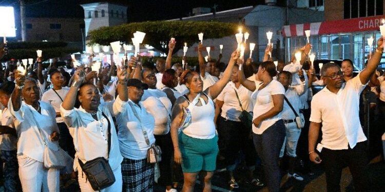 Participants lift their candles during the People’s National Movement’s (PNM) Candlelight Vigil in Defence of Democracy and Freedom in San Juan on Wednesday evening. —Photo: ISHMAEL SALANDY