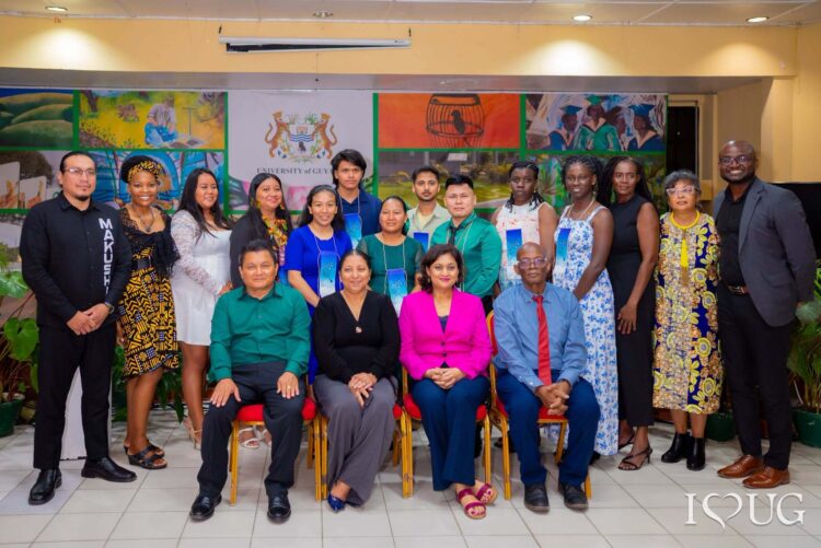 L-R seated: Lecturer of WAP1101 in the Guyanese Languages Unit (GLU), Dr. Adrian Gomes; Vice-Chancellor, Professor Paloma Mohamed Martin; Minister of Local Government and Regional Development, Hon. Priya Manickchand, MP; and Deputy Vice-Chancellor for Academic Engagement, Professor Emanuel Cummings.
R-L standing: Dean of the Faculty of Engineering and Technology, Dr. Kofi Dalrymple; Lecturer in the GLU, Ms. Charlene Wilkinson; Director of the International Centre of Excellence for Modern and Indigenous Languages, Literatures and Linguistics, Dr. Penelope Montfort; 9 students who graduated from the inaugural Wapichan Language Course; Coordinator of the GLU, Dr. Tamirand Nnena De Lisser; and Principal Regional Development Officer, Ministry of Amerindian Affairs, Mr. Anil Roberts.