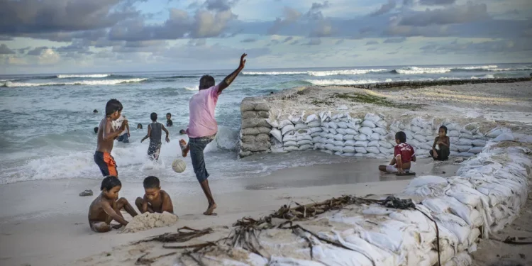 Children play on a fortified beach in Temwaiku, a village on the Tarawa atoll, the capital of the Pacific island nation of Kiribati.(NRDC/ NOOR photo)