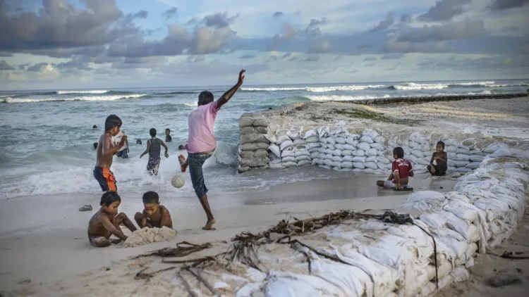 Children play on a fortified beach in Temwaiku, a village on the Tarawa atoll, the capital of the Pacific island nation of Kiribati.(NRDC/ NOOR photo)