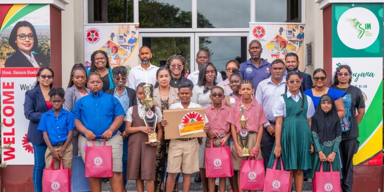 Executive Director of GNBS, Trevor Bassoo, flanked by finalists of the competition, teachers, parents and representatives from GNBS