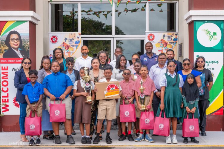 Executive Director of GNBS, Trevor Bassoo, flanked by finalists of the competition, teachers, parents and representatives from GNBS
