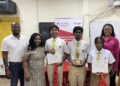 Jamaican STEM educator Kavelle Hylton (right) and Macmillan Education Caribbean Regional Officer Alex Holder (left) join students from Queen’s College following the presentation ceremony held after Wednesday’s STEM workshop.