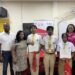 Jamaican STEM educator Kavelle Hylton (right) and Macmillan Education Caribbean Regional Officer Alex Holder (left) join students from Queen’s College following the presentation ceremony held after Wednesday’s STEM workshop.