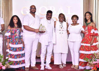 Waynewright Orderson (third from left) receives the Global Piton Award from Christopher Gustave Marketing Manager Caribbean, Sports & Events at Saint Lucia Tourism Authority (second from left) while other officials of the Saint Lucia Tourism Authority look on