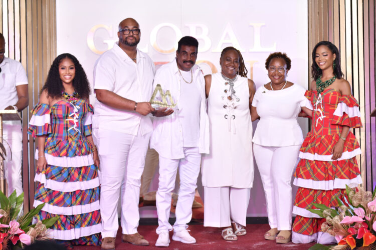 Waynewright Orderson (third from left) receives the Global Piton Award from Christopher Gustave Marketing Manager Caribbean, Sports & Events at Saint Lucia Tourism Authority (second from left) while other officials of the Saint Lucia Tourism Authority look on