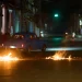 People drive a classic American car through a barricade set up by residents protesting against prolonged power outages in Havana, Cuba, Wednesday, May 13, 2026. (AP Photo/Ramon Espinosa)