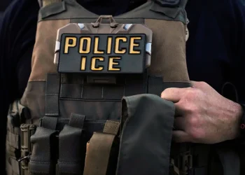 A U.S. Immigration and Customs Enforcement agent is seen in Park Ridge, Ill., Sept. 19, 2025. (AP Photo/Erin Hooley, File)