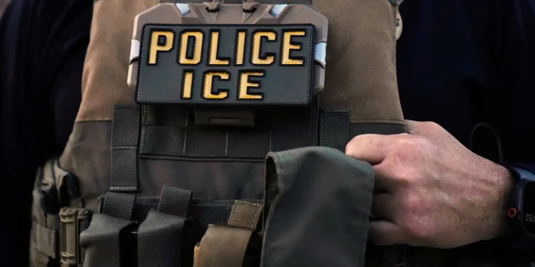 A U.S. Immigration and Customs Enforcement agent is seen in Park Ridge, Ill., Sept. 19, 2025. (AP Photo/Erin Hooley, File)