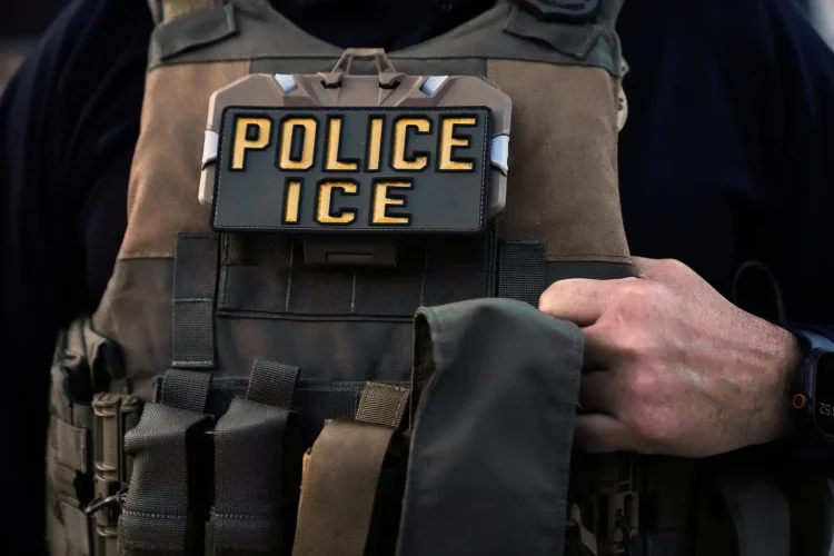 A U.S. Immigration and Customs Enforcement agent is seen in Park Ridge, Ill., Sept. 19, 2025. (AP Photo/Erin Hooley, File)
