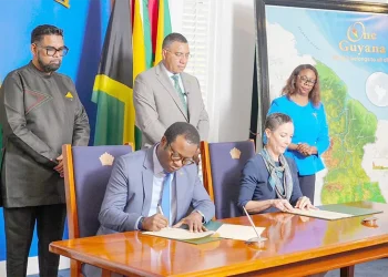President Dr. Irfaan Ali and Jamaican Prime Minister Dr. Andrew Holness witness the signing, on Friday at State House, of three Memoranda of Understanding intended to deepen cooperation between Guyana and Jamaica in agriculture, defence and security, and financial services (Office of the President photos)