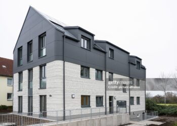 11 December 2024, North Rhine-Westphalia, Lünen: Completion of Germany's first publicly subsidized residential building from the 3D printer. North Rhine-Westphalia is leading the way in Germany with this pioneering project, bringing innovative construction and affordable housing under one roof. The construction project was financially supported as part of the state's "Innovation in the construction industry" funding and the North Rhine-Westphalia public housing promotion program. Photo: Guido Kirchner/dpa (Photo by Guido Kirchner/picture alliance via Getty Images)