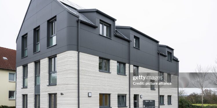 11 December 2024, North Rhine-Westphalia, Lünen: Completion of Germany's first publicly subsidized residential building from the 3D printer. North Rhine-Westphalia is leading the way in Germany with this pioneering project, bringing innovative construction and affordable housing under one roof. The construction project was financially supported as part of the state's "Innovation in the construction industry" funding and the North Rhine-Westphalia public housing promotion program. Photo: Guido Kirchner/dpa (Photo by Guido Kirchner/picture alliance via Getty Images)