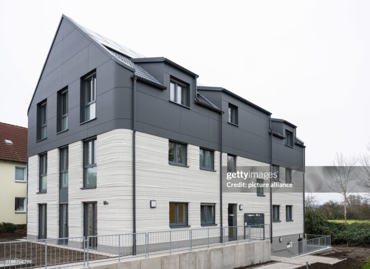 11 December 2024, North Rhine-Westphalia, Lünen: Completion of Germany's first publicly subsidized residential building from the 3D printer. North Rhine-Westphalia is leading the way in Germany with this pioneering project, bringing innovative construction and affordable housing under one roof. The construction project was financially supported as part of the state's "Innovation in the construction industry" funding and the North Rhine-Westphalia public housing promotion program. Photo: Guido Kirchner/dpa (Photo by Guido Kirchner/picture alliance via Getty Images)