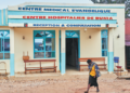 A woman walks past a hospital in Bunia, Democratic Republic of Congo, on July 3. The facility is a designated site scheduled to host clinical trials for Ebola treatments. DIROLE LOTSIMA DIEUDONN/AP