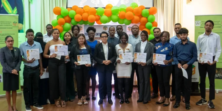 Minister of Tourism, Industry and Commerce, Susan Rodrigues, with recipients of the grants