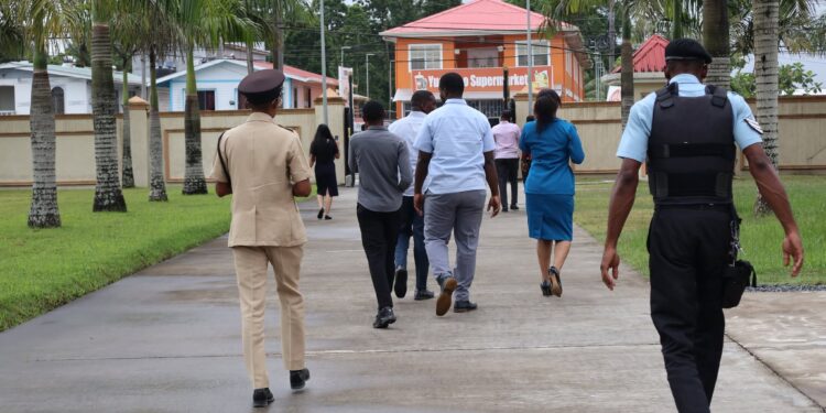 Police officers first entered the property, arriving by Guyana Police Force river patrol boat through Mohamed’s wharf from the Demerara River. After gaining access, they opened the entry gates from inside the property to facilitate the arrival of the remaining officers. (Team Mohamed's photo)