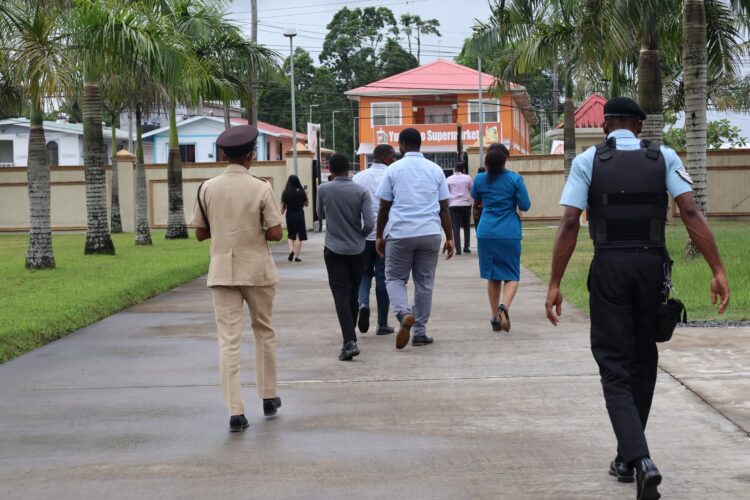 Police officers first entered the property, arriving by Guyana Police Force river patrol boat through Mohamed’s wharf from the Demerara River. After gaining access, they opened the entry gates from inside the property to facilitate the arrival of the remaining officers. (Team Mohamed's photo)