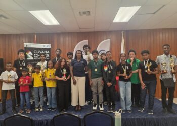 Prize Winners for the Junior Chess Championship Qualifiers posed with Ms. Yulanda Armstrong from EnerMech Guyana