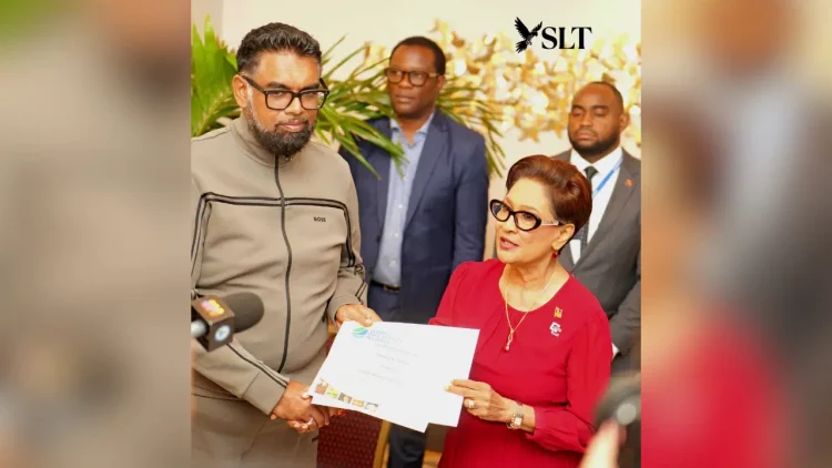 President Dr Mohamed Irfaan Ali hands over a Global Biodiversity Alliance membership certificate to Trinidad and Tobago’s Prime Minister Kamla Persad-Bissessar