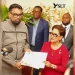 President Dr Mohamed Irfaan Ali hands over a Global Biodiversity Alliance membership certificate to Trinidad and Tobago’s Prime Minister Kamla Persad-Bissessar