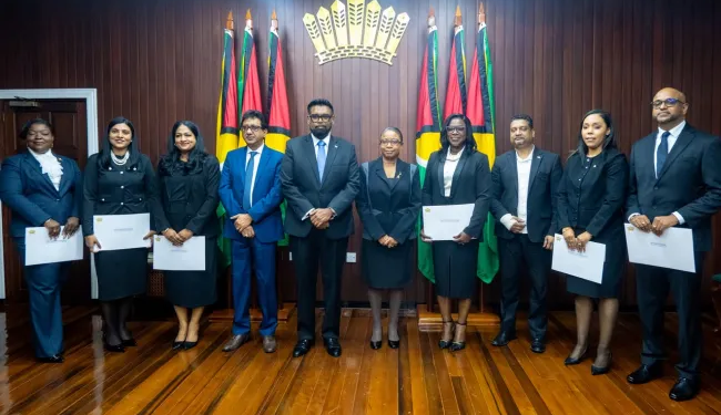 President Irfaan Ali, flanked by Attorney General Mohabir Anil Nandlall, SC, and the six newly appointed Puisne Judges
