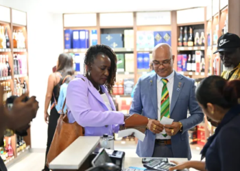 Chief Immigration Officer of Barbados purchasing at Guyana’s duty-free shop using her e-ID card (DPI photo)