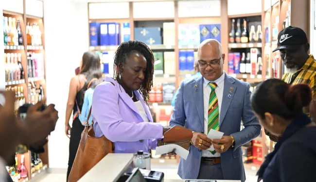 Chief Immigration Officer of Barbados purchasing at Guyana’s duty-free shop using her e-ID card (DPI photo)