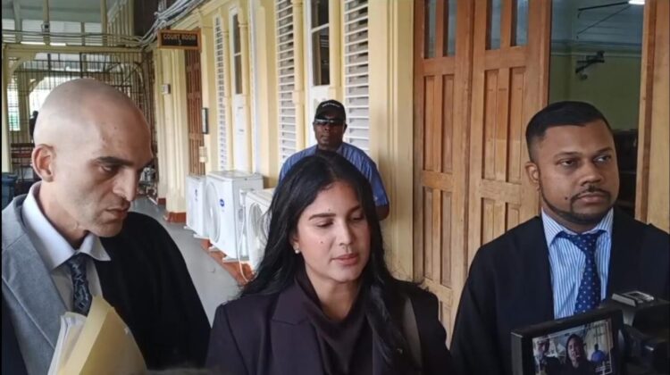 Attorneys Siand Dhurjon and Damien DaSilva with Hana Mohamed outside of the court room. (Kaieteur News photo)