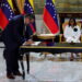 FILE PHOTO: Venezuela's interim President Delcy Rodriguez looks on as Mariano Vela, President of Chevron in Venezuela signs an oil agreement between Chevron and Venezuela's state oil company PDVSA, in Caracas, Venezuela April 13, 2026. REUTERS/Leonardo Fernandez Viloria/File Photo