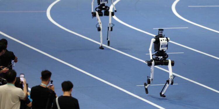 Robots of Tiangong compete during the 4x100m Relay of the 2nd World Humanoid Robot Games in Beijing, capital of China, Aug. 25, 2026. (Xinhua/Zhang Chenlin)