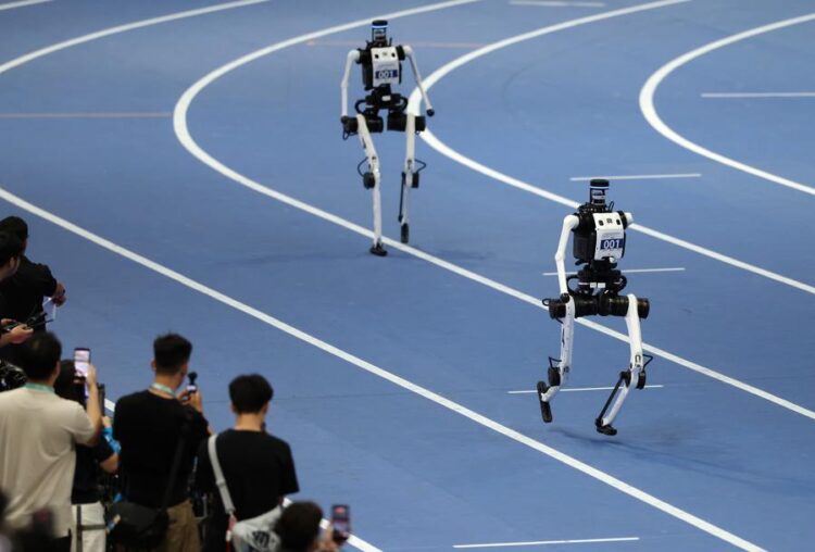 Robots of Tiangong compete during the 4x100m Relay of the 2nd World Humanoid Robot Games in Beijing, capital of China, Aug. 25, 2026. (Xinhua/Zhang Chenlin)