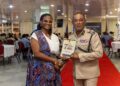 CEO Outliers Zone Caribbean & Commissioner of Police Cliffon Hicken with the Financial Readiness Manual for disciplined services