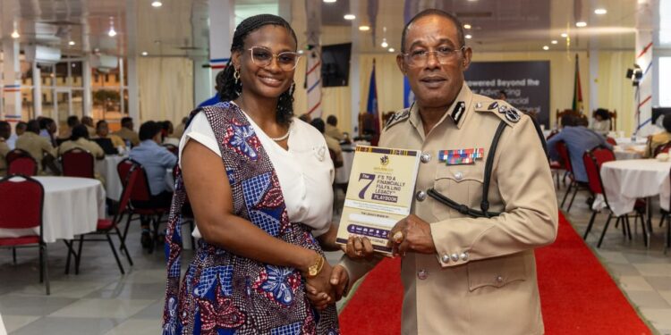 CEO Outliers Zone Caribbean & Commissioner of Police Cliffon Hicken with the Financial Readiness Manual for disciplined services