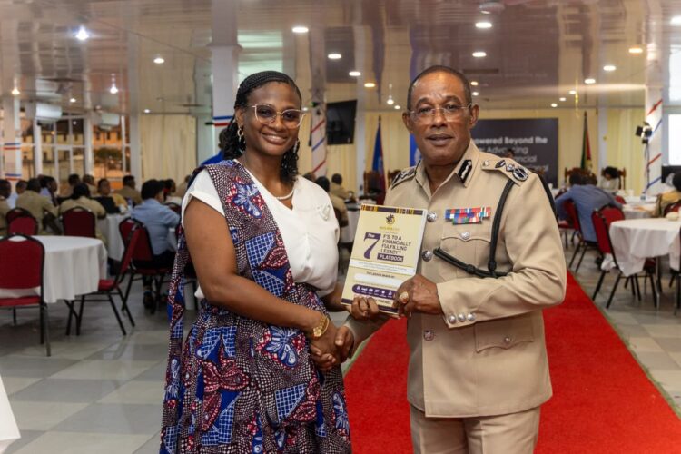CEO Outliers Zone Caribbean & Commissioner of Police Cliffon Hicken with the Financial Readiness Manual for disciplined services