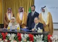 Members of the consortium of Saudi and international private investors pose with ILO's Maha Kattaa, the Ministry of Energy's Ousama Abo Zaid (standing), and Herafi's Ibrahim Al-Ameer (seated) at a public-private renewable energy event, in Damascus, August (ILO photo)