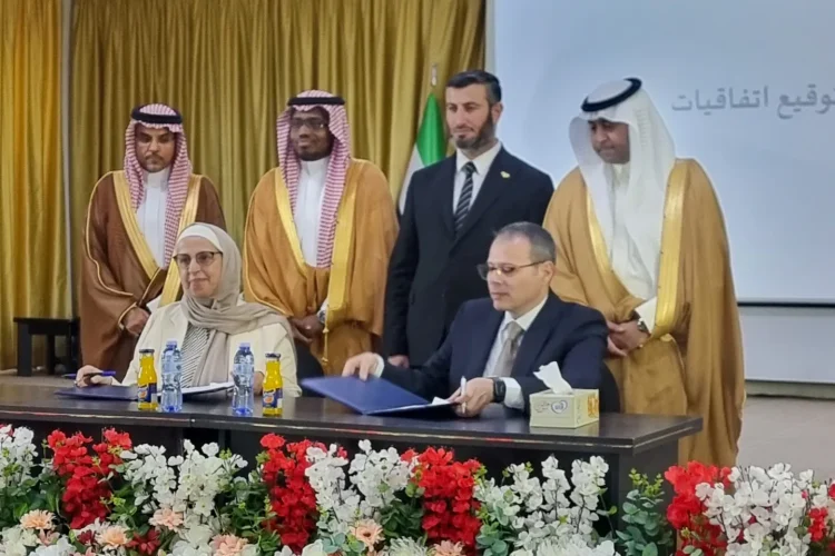 Members of the consortium of Saudi and international private investors pose with ILO's Maha Kattaa, the Ministry of Energy's Ousama Abo Zaid (standing), and Herafi's Ibrahim Al-Ameer (seated) at a public-private renewable energy event, in Damascus, August (ILO photo)