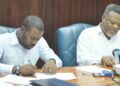 L-R Then Region 10 Regional Chairman Sharma Solomon and then Prime  Minister Sam Hinds signing the Agreement- August 21, 2012