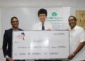 L – R: BRITCHAM’s Secretary, Anand Harrilall hands over check to Iwokrama’s CEO, Dane Gobin, in the presence of British High Commissioner, Joseph Fisher (Centre).