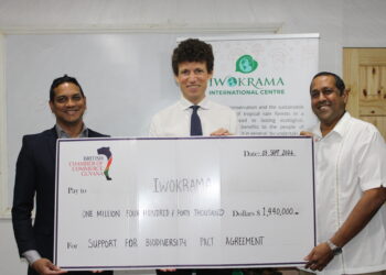 L – R: BRITCHAM’s Secretary, Anand Harrilall hands over check to Iwokrama’s CEO, Dane Gobin, in the presence of British High Commissioner, Joseph Fisher (Centre).