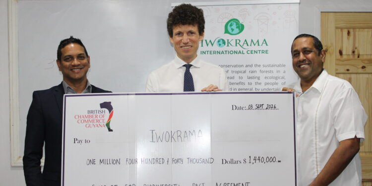 L – R: BRITCHAM’s Secretary, Anand Harrilall hands over check to Iwokrama’s CEO, Dane Gobin, in the presence of British High Commissioner, Joseph Fisher (Centre).