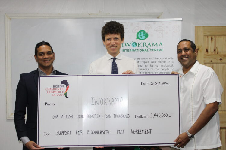 L – R: BRITCHAM’s Secretary, Anand Harrilall hands over check to Iwokrama’s CEO, Dane Gobin, in the presence of British High Commissioner, Joseph Fisher (Centre).