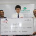 L – R: BRITCHAM’s Secretary, Anand Harrilall hands over check to Iwokrama’s CEO, Dane Gobin, in the presence of British High Commissioner, Joseph Fisher (Centre).