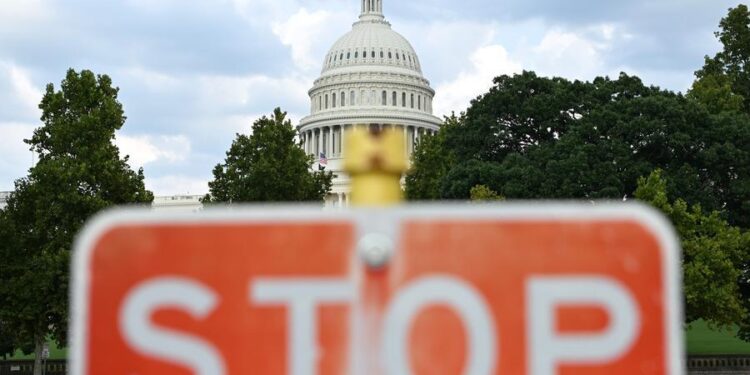 This photo, taken on Aug. 28, 2026, shows a stop sign with the U.S. Capitol building in the background in Washington, D.C., the United States. (Xinhua/Li Rui)