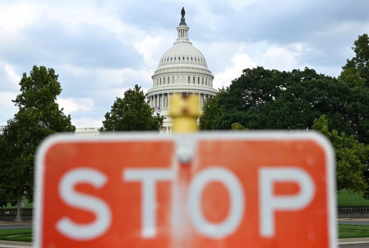 This photo, taken on Aug. 28, 2026, shows a stop sign with the U.S. Capitol building in the background in Washington, D.C., the United States. (Xinhua/Li Rui)
